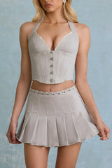 Low-Rise Pleated Mini Skirt in Ecru